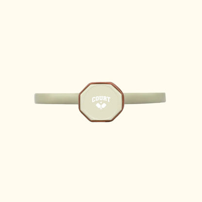 bottom logo of Court pickleball paddle showing a white company logo on beige